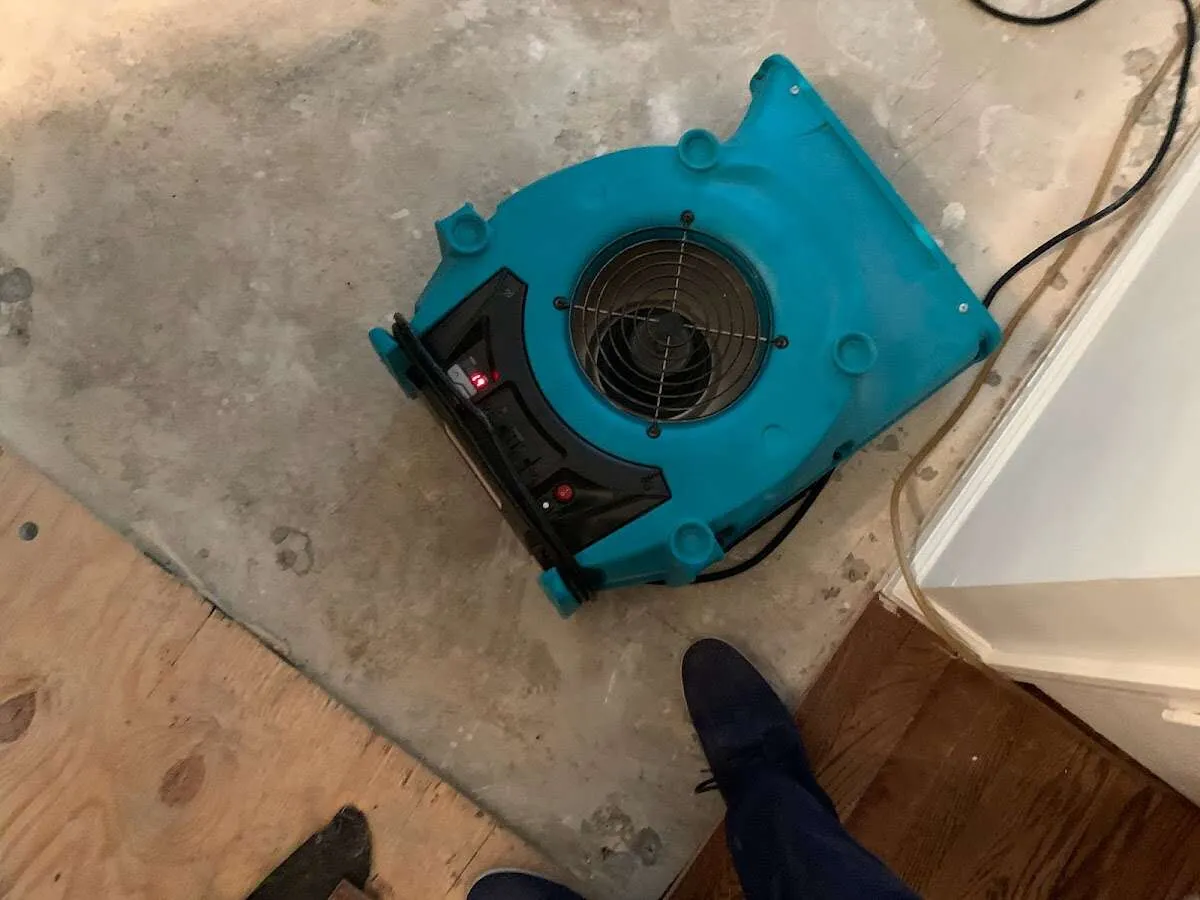 Air mover drying subfloor during Commercial Water Damage Restoration in Brooklyn Park